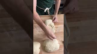 Shaping a sourdough batard.