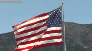 preview picture of video 'American flag blowing in the wind with a mountain behind it - youtube.com/tanvideo11'
