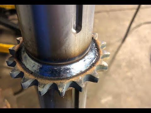 Welding hardened sprocket to shaft with dual shield