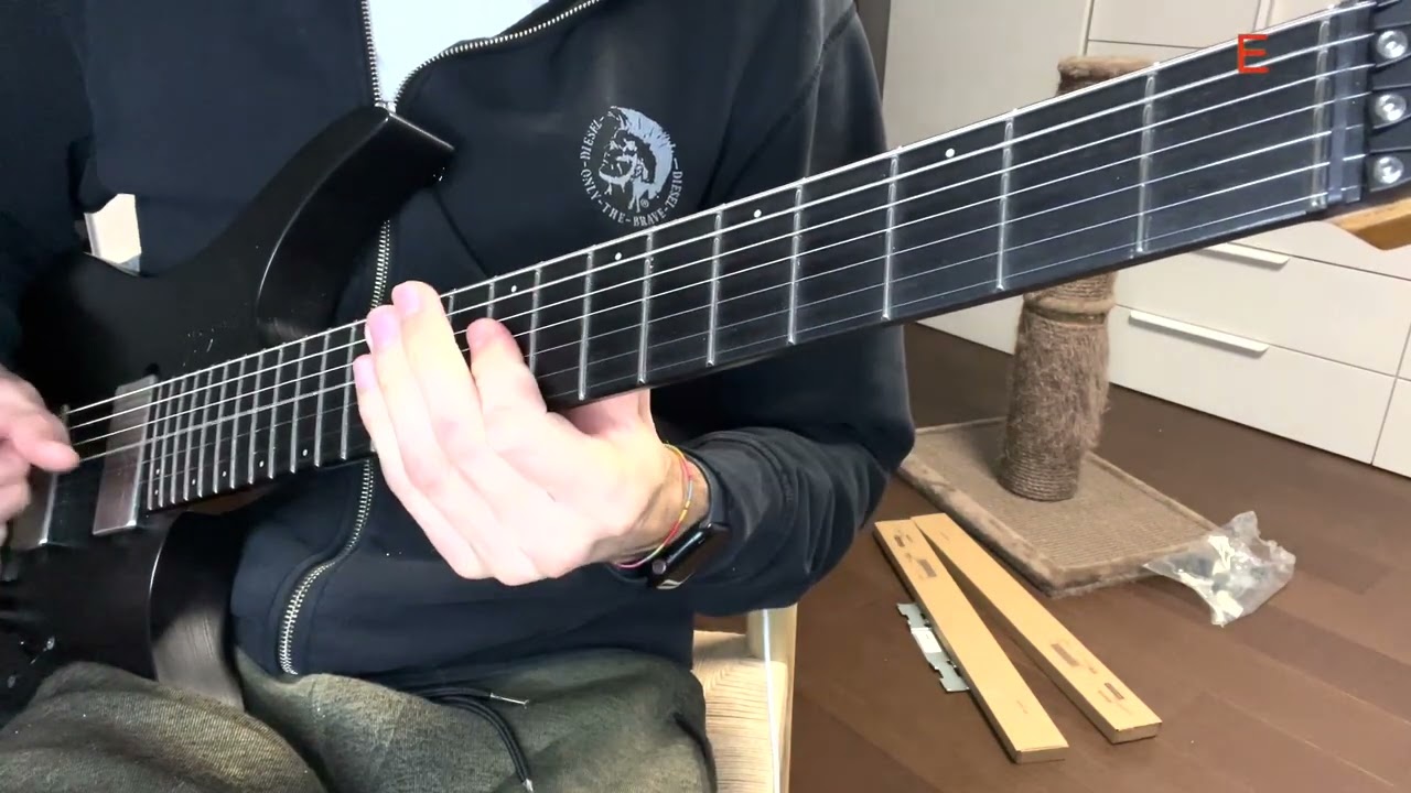 Guitarist playing a major triad on the middle B, G and D strings for a voice leading exercise
