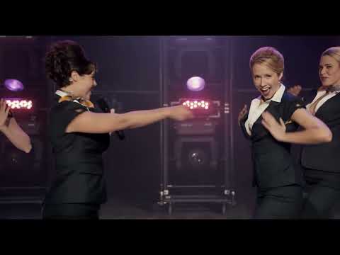 Trailer montage: underground pool riff-off circle and a Bellas stage tableau under magenta light