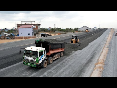 Powerful Komatsu D41P Bulldozer Spreading Gravel And Dump Trucks Unloading Gravel Building New Road