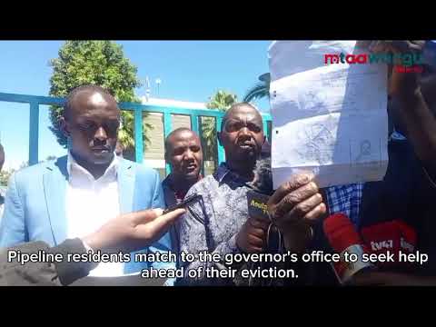 Pipeline residents march to the governor's office to seek help ahead of their eviction