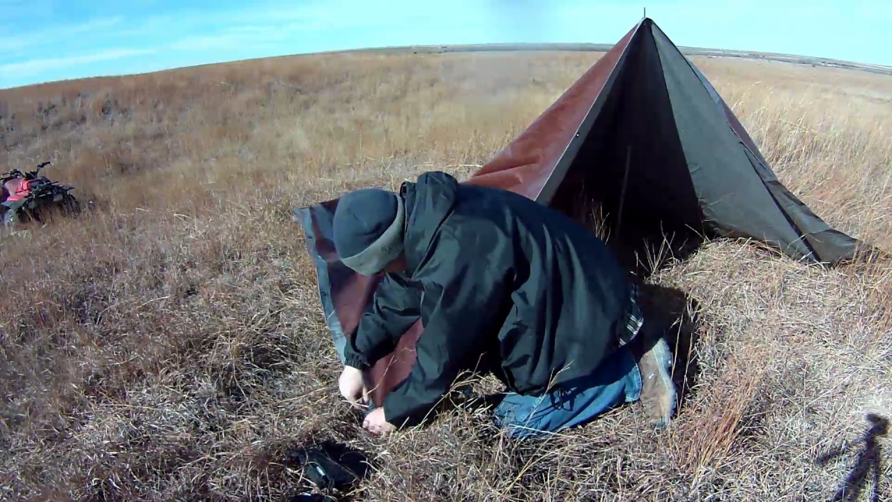 Tarp setup on the Plains allows for camp fire and blocks wind.