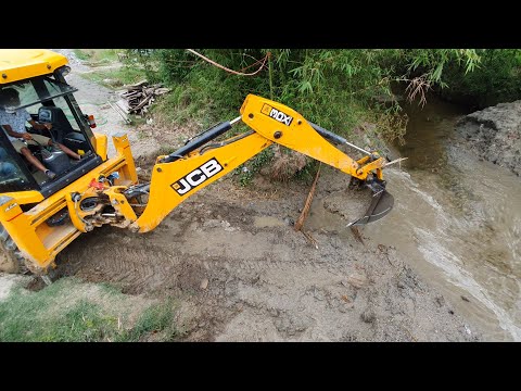 JCB Throwing Out Water With Bucket - JCB Backhoe Machine Working For Bridge Wall Construction