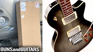Video thumbnail for Unboxing a CHEAP LP STYLE guitar with FLOYD ROSE style tremolo (first impressions) by Guns and Guitars