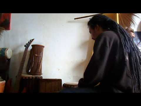 Butoyi touches the drums with sticks