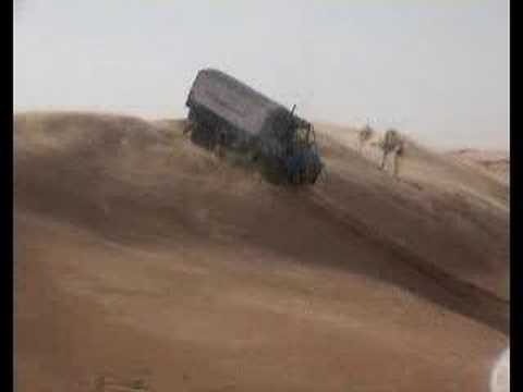 Unimog truck in Sahara desert doing steep dune descent