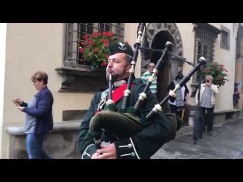 lone piper in the rain for the scottish week in barga italy