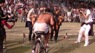 Riding a bicycle with burnt wheels at Kila Raipur Olympics