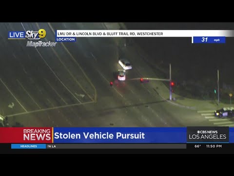 Suspect blows through red light, nearly hits passing car