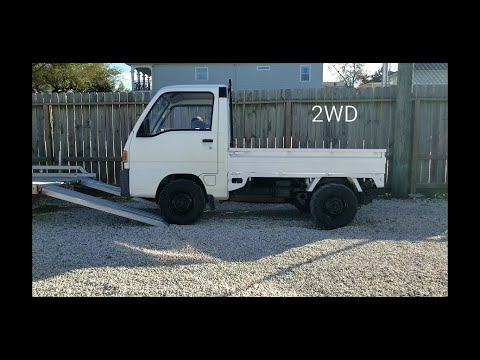 2WD vs 4WD minitruck comparison loading on trailer.