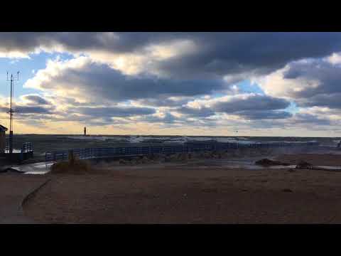 Lake Michigan waves crash along Holland pier