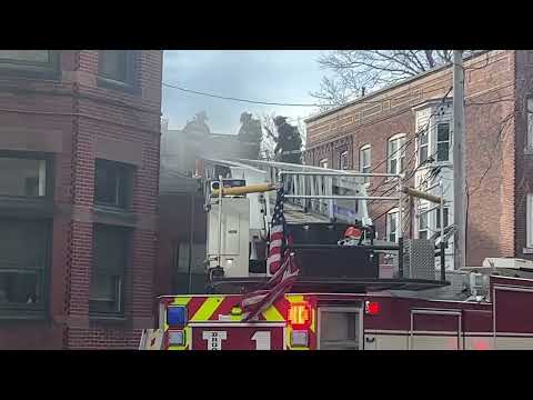 Brookline, MA Fire department ladder 1 ventilating the roof of a fire