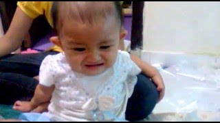 Cute baby crying scared by daddy squeeze the rubber duck toy