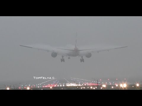 Airplanes landing in thick fog conditions and near-zero visibility at London Gatwick airport