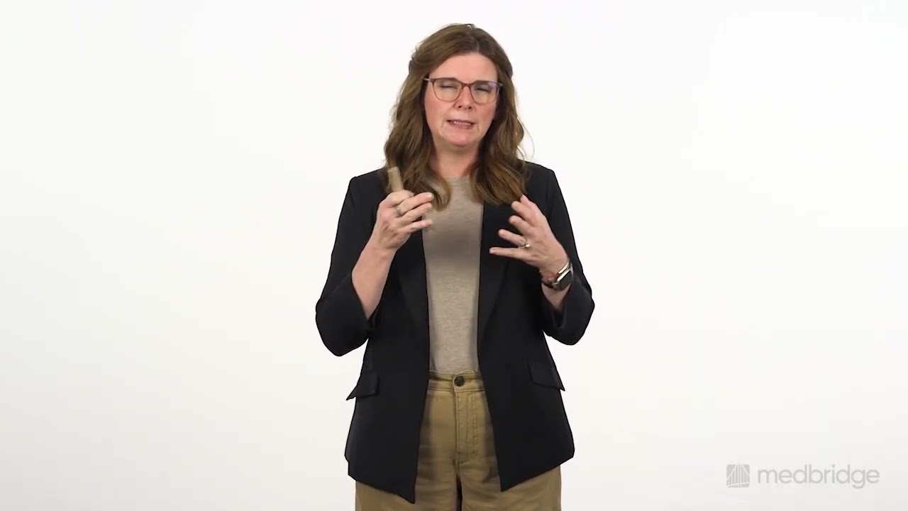 A woman with glasses in business attire gestures with both hands against a white background, representing medbridge innovation.