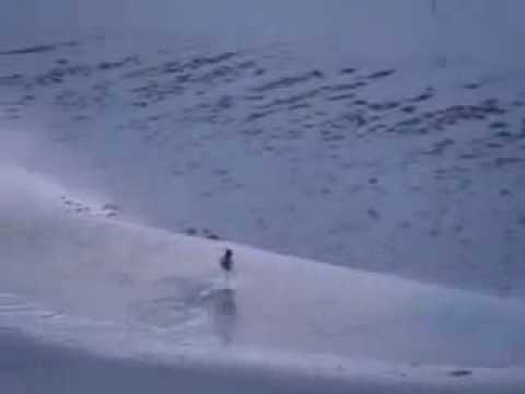 Man does an impressive flip down a sand dune.