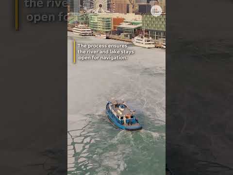 Drone shows tugboat carving a path through frozen Chicago river