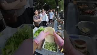 The process of making and selling pork tenderloin pancakes at a street stall