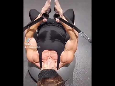 Sheila Bleck. IFBB pro. in flow motion cable cross overs on pallet ball to isolate pecs