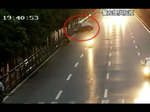 Surveillance Video Shows Car Crashing into Roadside Barrier