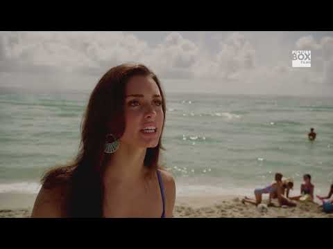 Trailer still of the corporate office flash mob with dancers in suits bursting from elevators
