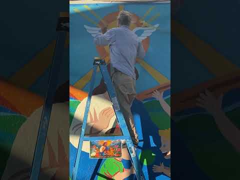 Watch Zack Zublena painting the Holy Spirit on the St. Mel School mural