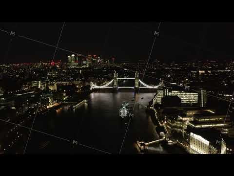 Aerial view of Tower bridge over Thames river at night. Famous landmark illuminated by bright light