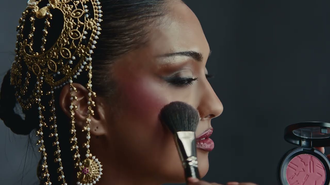 Five models in ornate festive Indian bridal wear pose against a grey studio backdrop