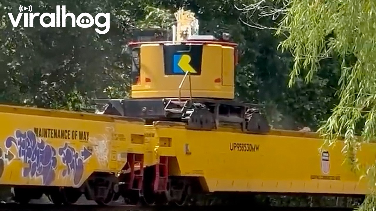 Train-Mounted Excavator Removes Debris From Tracks || ViralHog