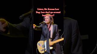 John Waite - Pulled over for speeding to his own concert in Dodge City, KS! Deputy is in attendance
