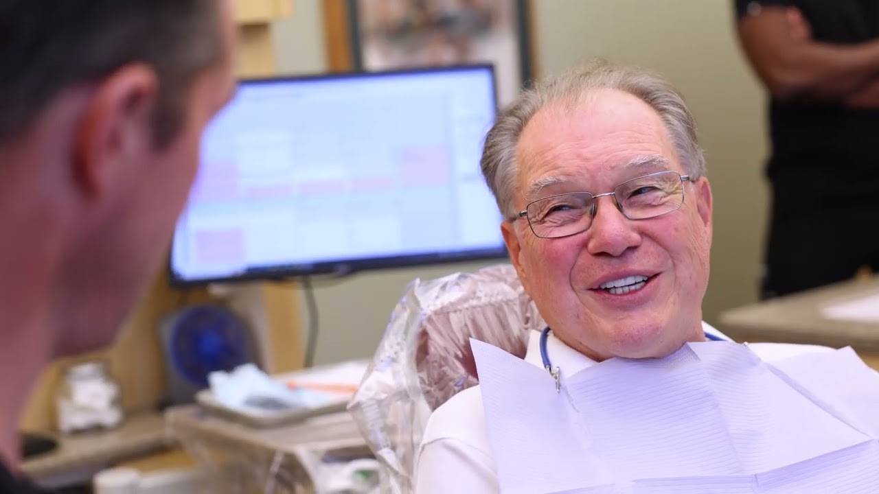Lakewood dental team member talking to a dental patient in waiting room
