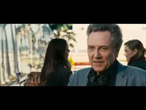 Seven Psychopaths official trailer still with Colin Farrell driving at night as neon reflections flicker