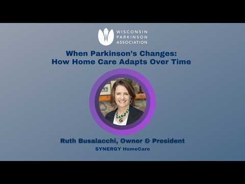 Senior woman in wheelchair enjoying time in the park with caregiver