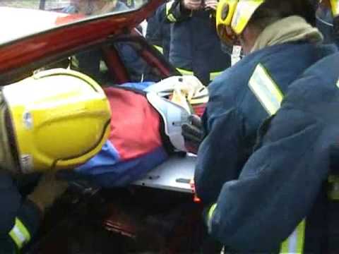 Demonstration of rapid extrication of casualty from a crash vehicle using a living fire training drill drag dummy mannequin-man performming as a drag dummy: Demonstration of rapid extrication of casualty from a crash vehicle using a living fire training drill drag dummy at West Midlands Fire Service BTC, Smethwick, Birmingham for West Mids Fire Service on 10/05/2004