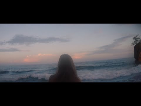 Lady on beach looking out at waves