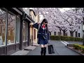 A Japanese Schoolgirl Walking Down A Street