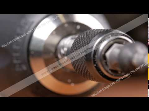 The screw is wearing a bit of electric screwdriver. Macro photography moving camera