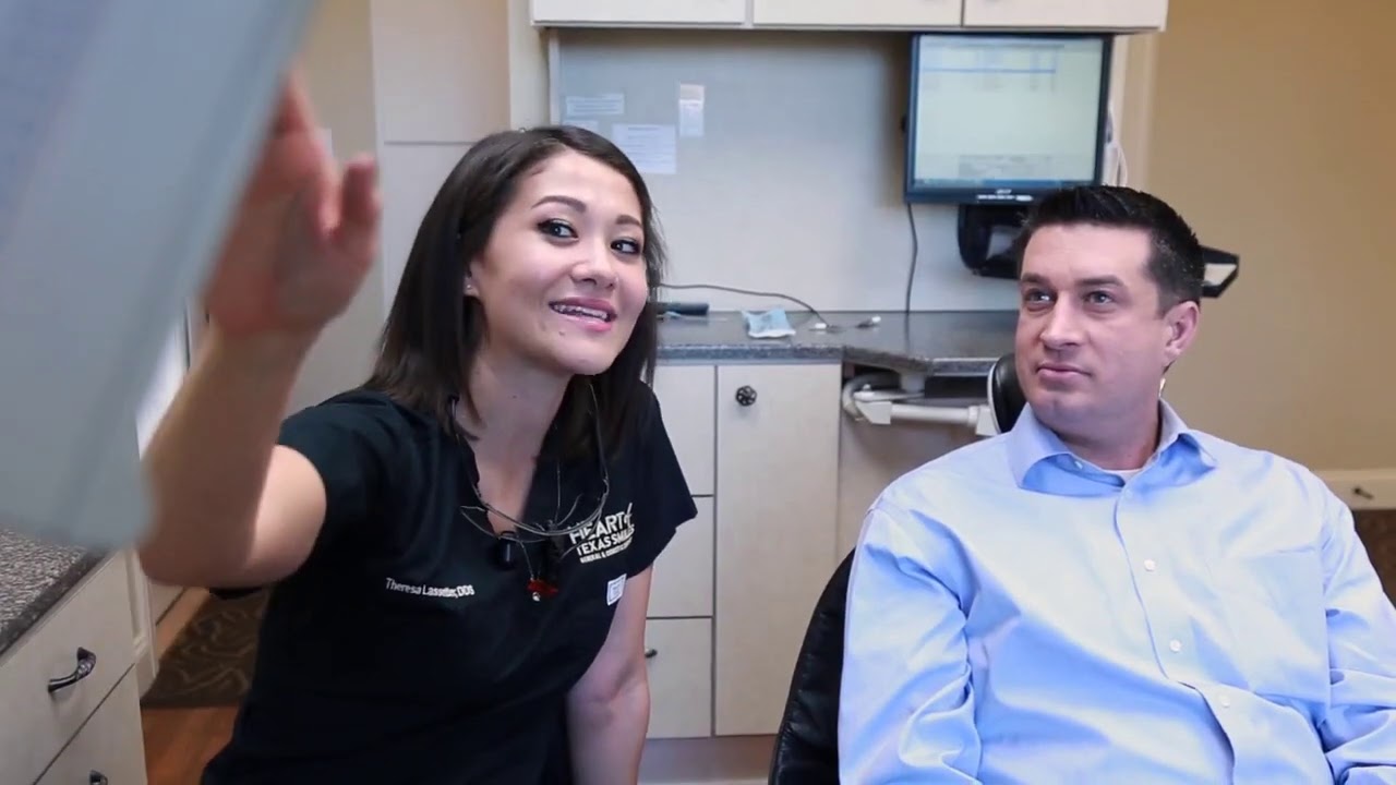 Dentist showing a patient a screen