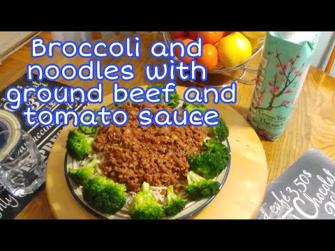 Broccoli and noodles with ground beef and tomato sauce.
