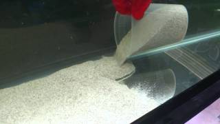 Adding sand without clouding the water