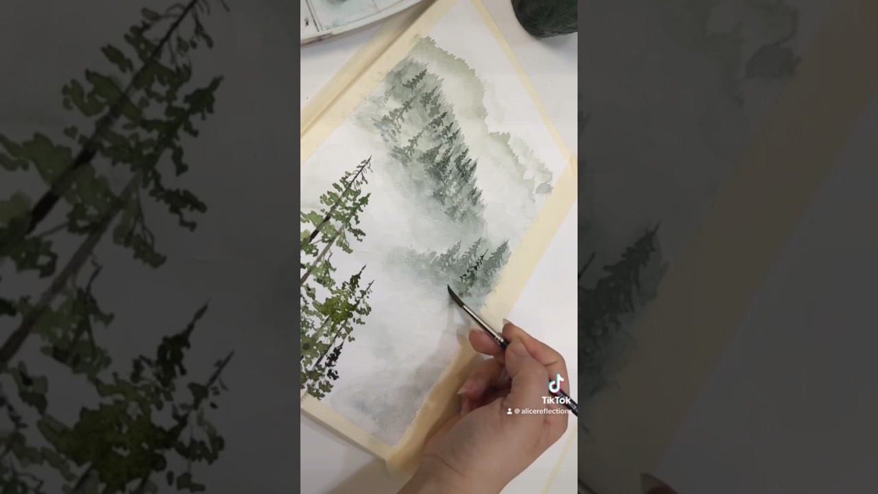 Watch the step by step tutorial in the videos section - Watercolour painting of a foggy pine forest