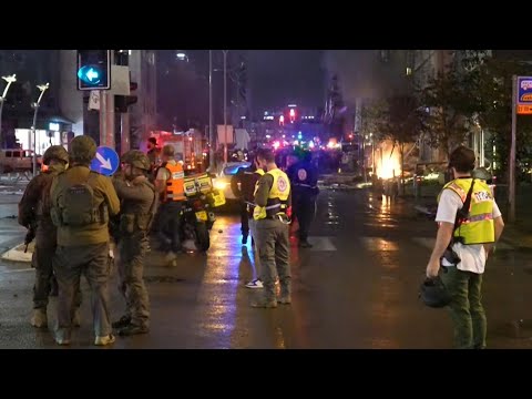 First responders assess damage after projectiles hit central Israel | AFP