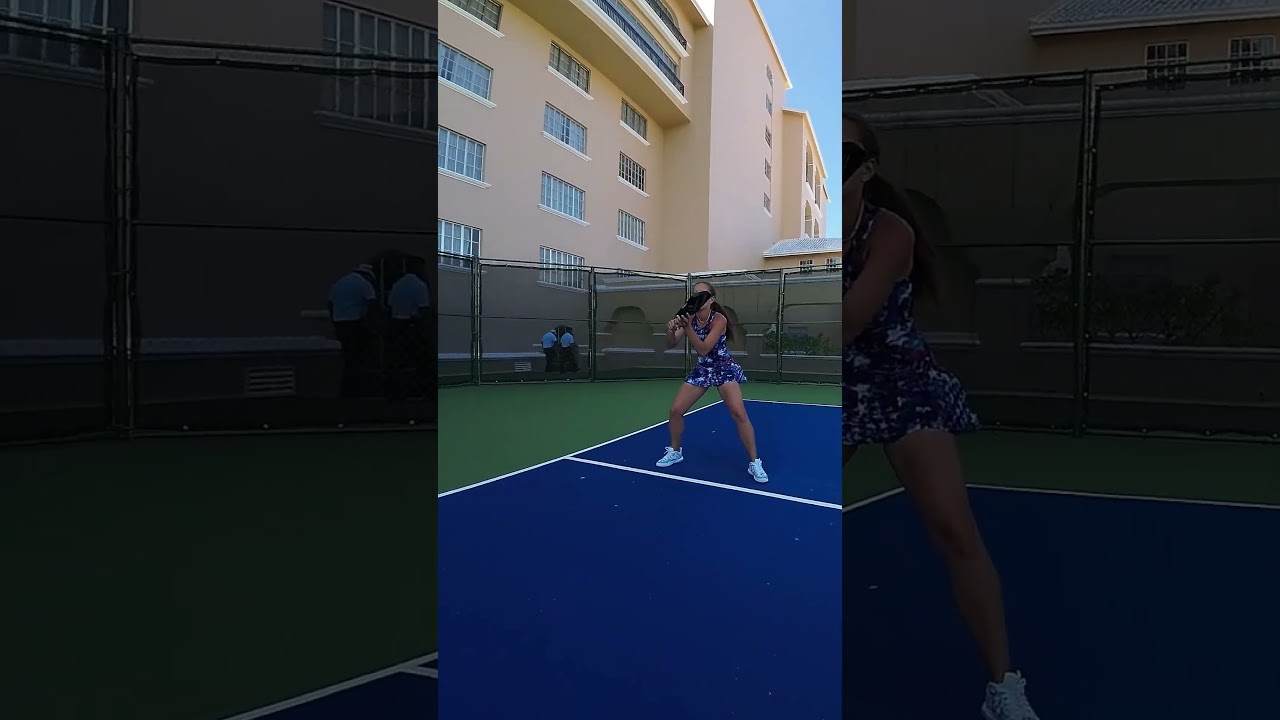 Player holding ready position on a blue resort pickleball court