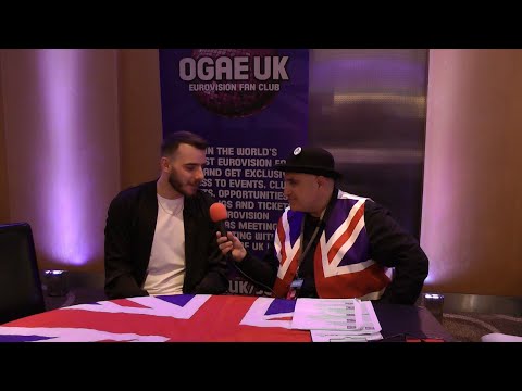 OGAE UK's Hass Yusuf talks to Krystian Ochman from Poland at the London Eurovision Party 2022