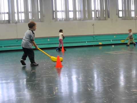 Little Boy Passes Puck in Nerf Hockey