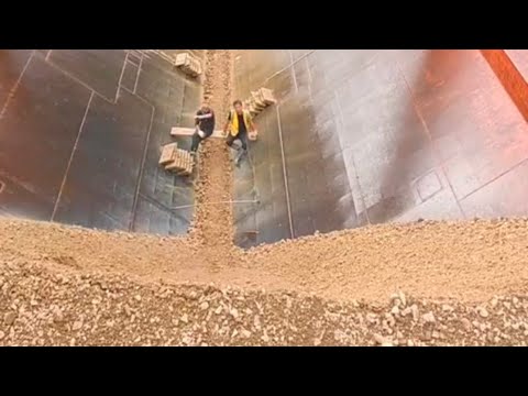Barge unloading large sandstone and pebbles - relaxing video
