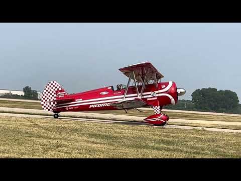 Susan Dacy and her Stearman, “Big Red”, taxi past at AirVenture, 2023