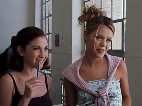 Trailer frame: night street outside the party; diegetic pop blaring from a house as characters arrive